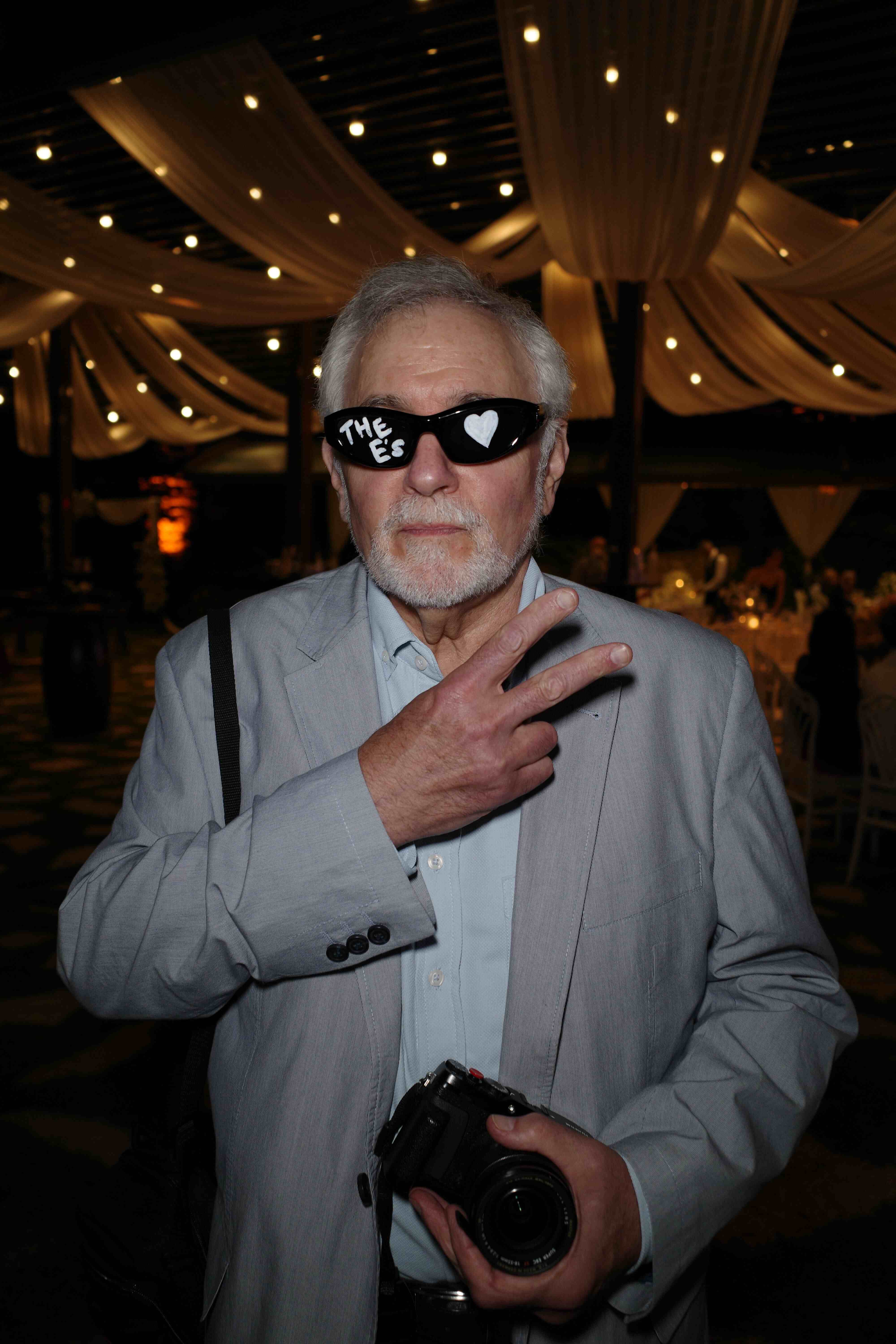 Older man posing with peace sign